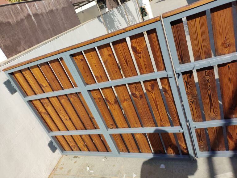modern-metal-framed-wooden-driveway-gate-secure-entrance-with-wood-slats